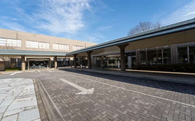 相模原市営斎場の車寄せの屋根と車路(矢印)